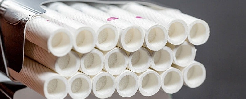 Open pack full of filter cigarettes closeup